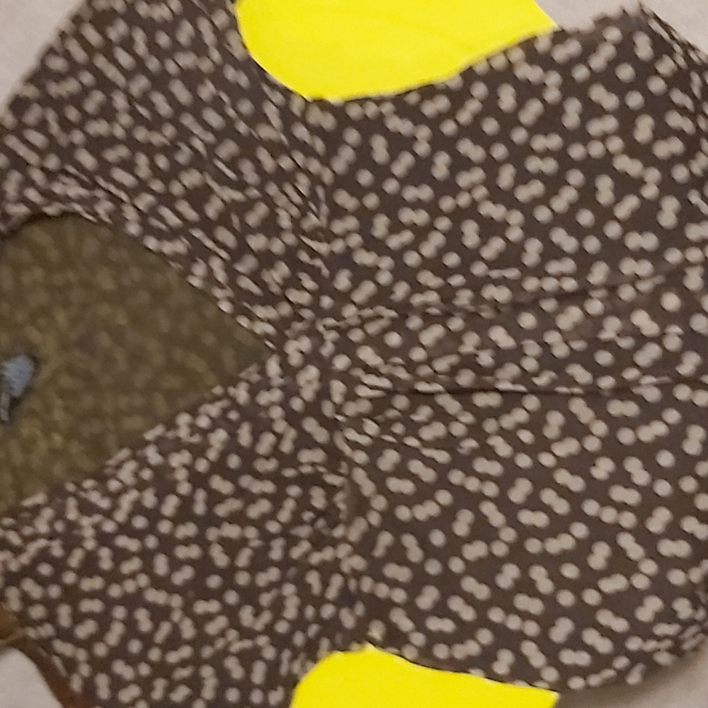 Brown shirt has a little bit of a slit on the chest